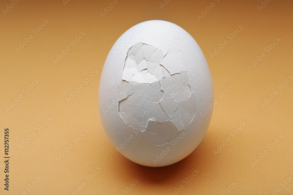 Cracked egg on color background