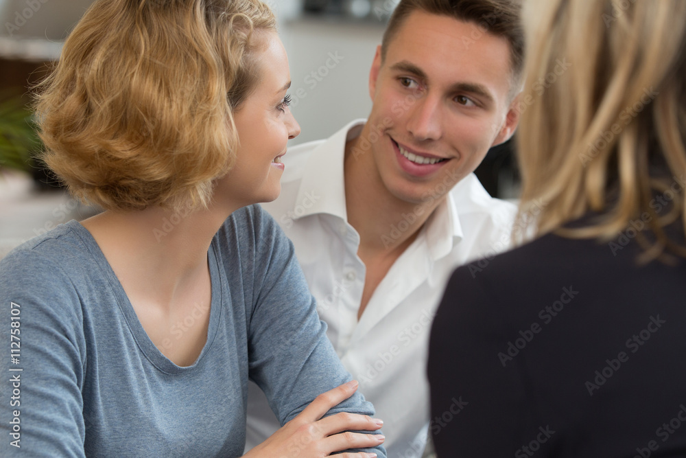 couple meeting real-estate to buy first home couple meeting real-estate to buy first home