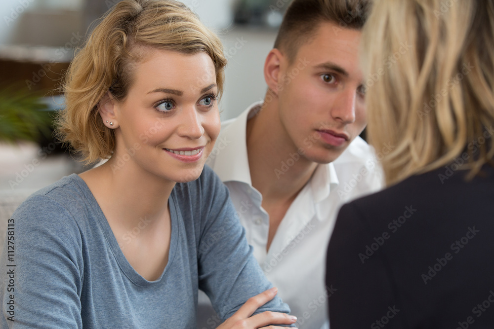 couple meeting real-estate to buy first home couple meeting real-estate to buy first home