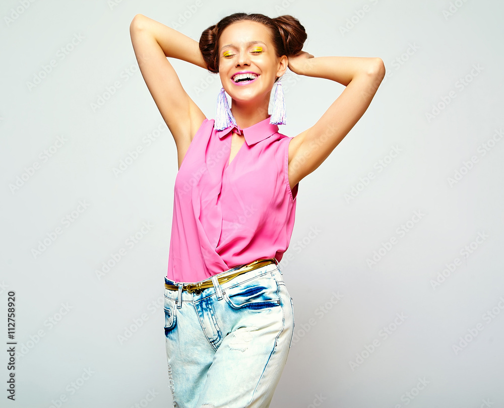 portrait of cheerful fashion hipster girl in casual colorful vivid hipster blue and pink summer clothes jeans on gray background portrait of cheerful fashion hipster girl in casual colorful vivid hipster blue and pink summer clothes jeans on gray background