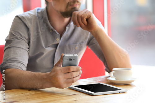 Businessman with gadgets in cafe