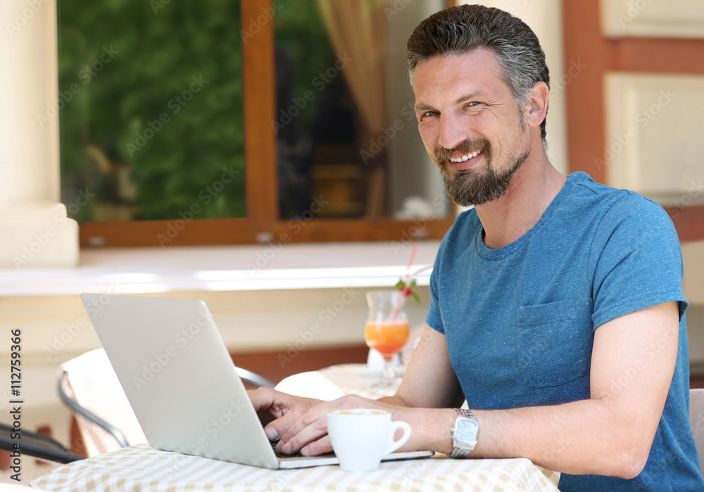 Businessman working with laptop in cafe Businessman working with laptop in cafe