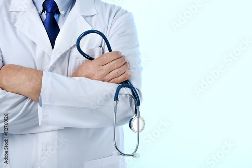 Professional doctor with stethoscope, isolated on white