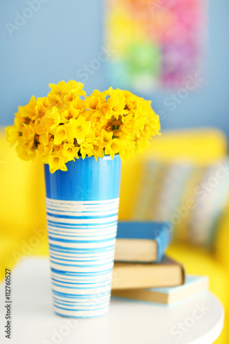 Beautiful bouquet of yellow narcissus on table