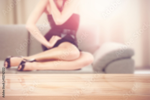 table background with woman legs on sofa 