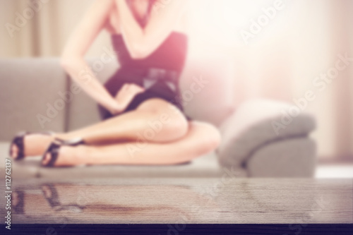 table background with woman legs on sofa 