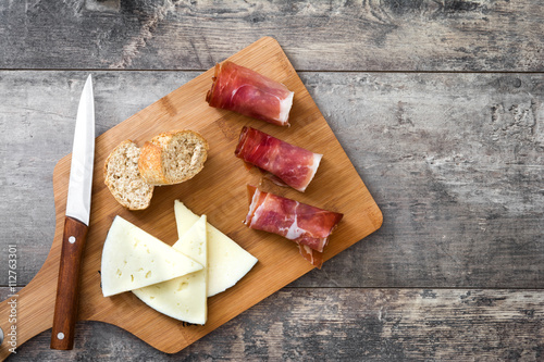Spanish serrano ham, cheese and sausage on a rustic wooden background 