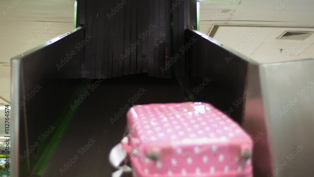 Clip of luggage coming out onto baggage carousel and going by in baggage claim hall, luggage conveyor Clip of luggage coming out onto baggage carousel and going by in baggage claim hall, luggage conveyor