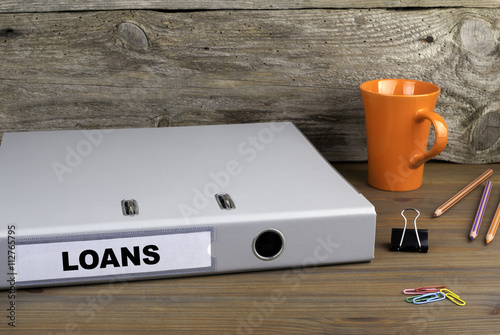 Loans - folder on wooden office desk
