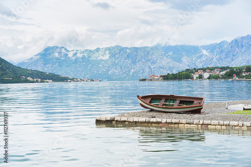 Harbour and boat at Boka Kotor bay (Boka Kotorska), Montenegro, Europe.