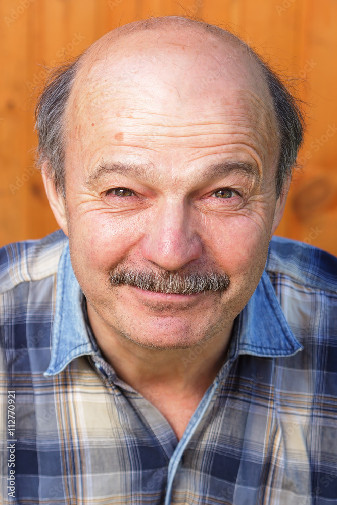 older man squinting from the sun. Good mood during the holidays older man squinting from the sun. Good mood during the holidays