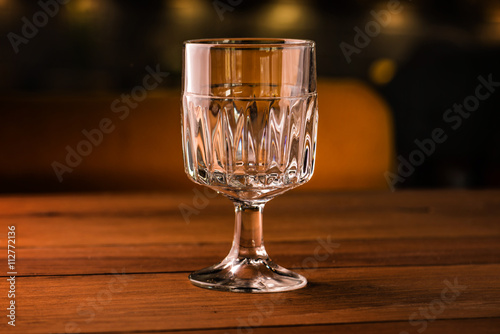Empty glass on table in night club