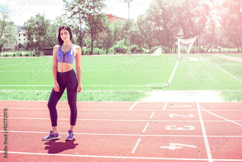 Woman on athletic running track.