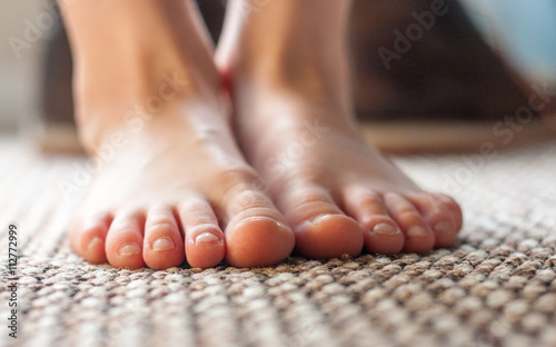 Young boys feet standing on carpet
