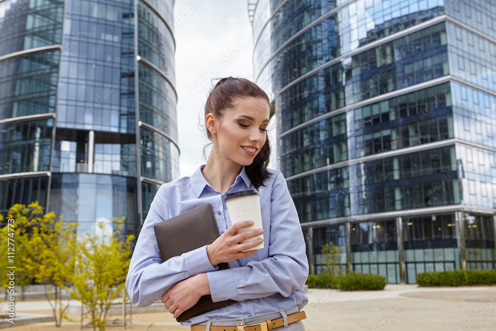 Woman drinking coffee and reading her touchscre Woman drinking coffee and reading her touchscre