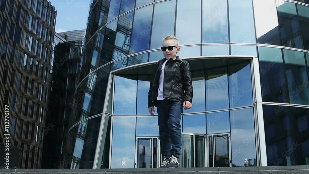 baby boy 7 - 8 years in a black leather jacket dancing baby boy 7 - 8 years in a black leather jacket dancing