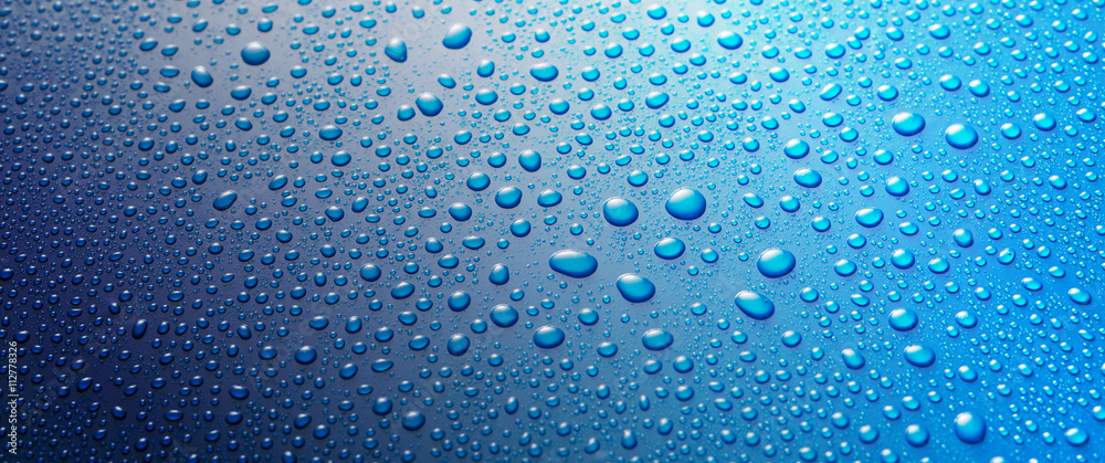 Panoramic banner of water drops on blue metal