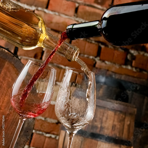 Red and white wine pouring