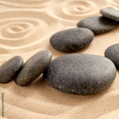 Photography Close up of zen garden with group of black stones