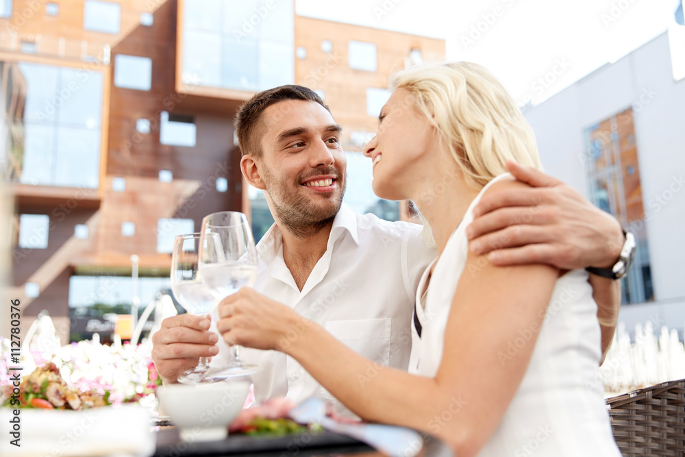 happy couple drinking wine at open-air restaurant happy couple drinking wine at open-air restaurant