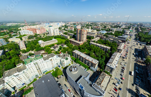 Aerial city view with crossroads and roads  houses  buildings  parks and parking lots  bridges. Copter shot. Panoramic image.