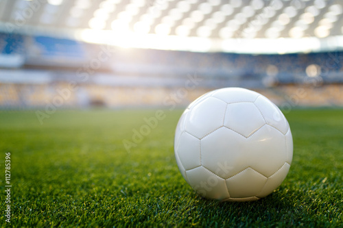 sport and lifestyle concept. Soccer ball on field and stadium tr © basin_stock