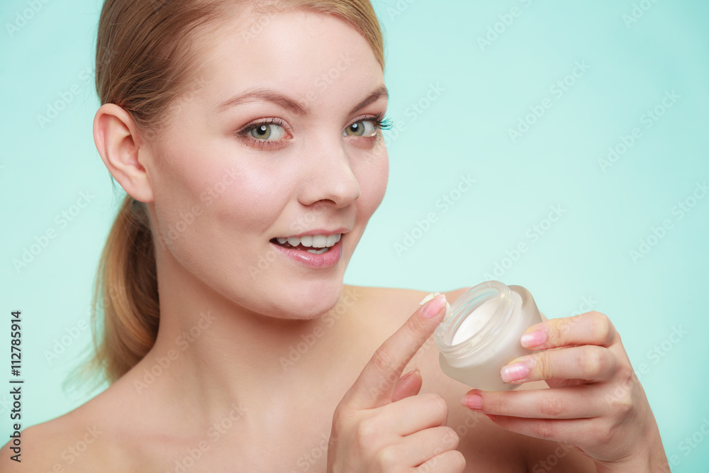 woman applying cream on her skin face. woman applying cream on her skin face.