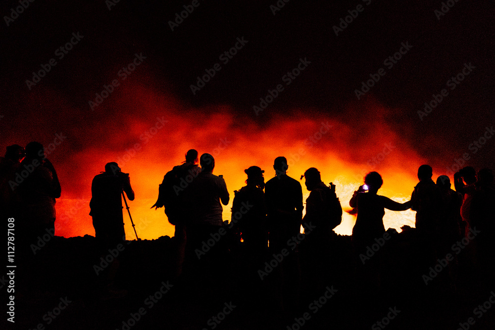 Silhouette of people by glowing light