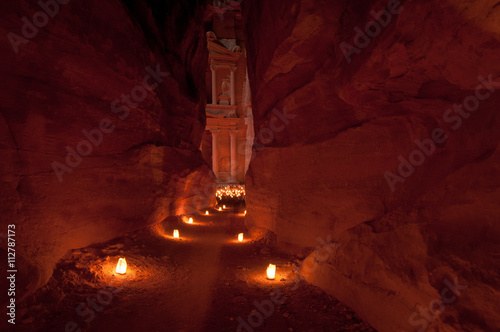 Narrow passageway to petra illuminated by candlelight