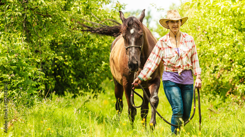 Western cowgirl woman with horse. Sport activity