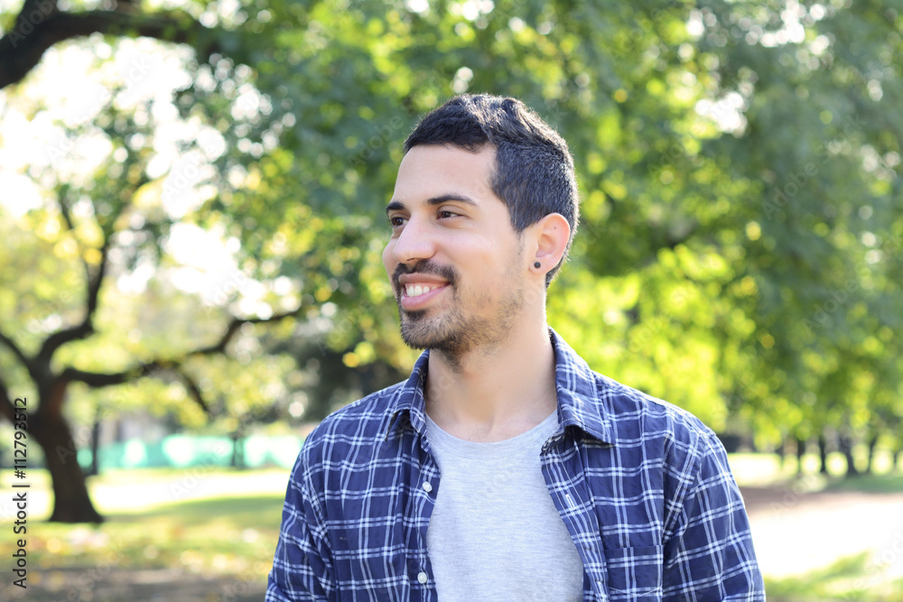 Close up of young man in a park.