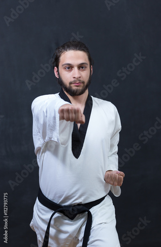White Karate Fighter Isolated On Black With Copyspace