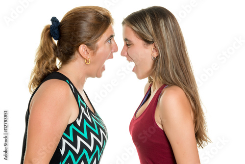 Angry mother and her teenage daughter yelling at each other photo