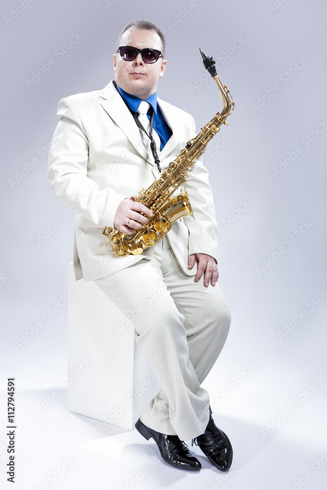 Naklejka premium Music Concept and Ideas. Full Length Portrait of Caucasian Musician With Alto Saxophone