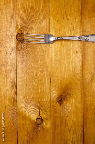 Fork on wooden background