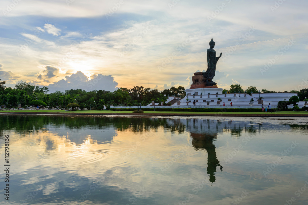Big Buddha statue at the lake in sunset time