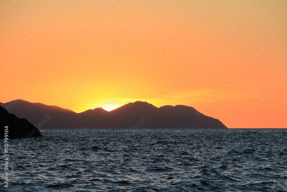 Sunset over islands in the Whitsunday's Australia over water