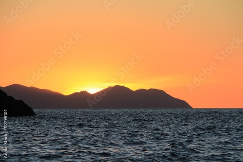 Sunset over islands in the Whitsunday's Australia over water