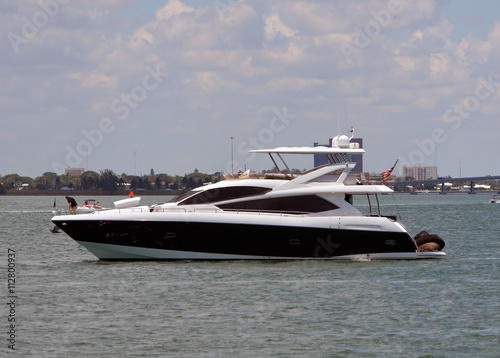 Luxury black and white motor yacht at idle on the florida intra-coastal water way off the venetia causeway in miami beach.