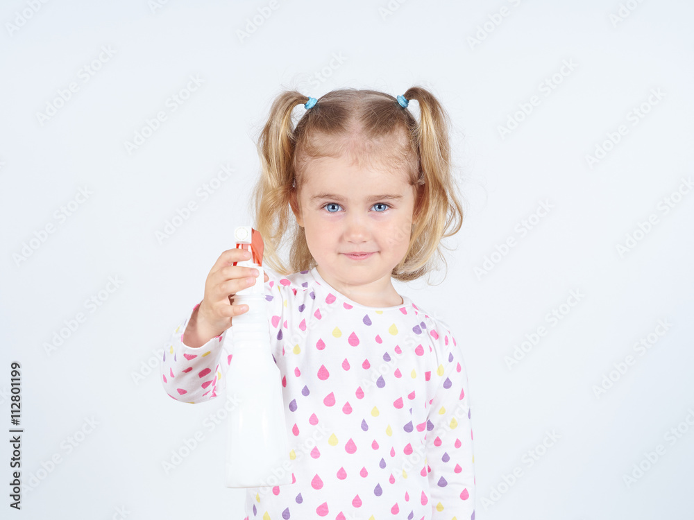 Little girl holding a watering spray bottle Little girl holding a watering spray bottle