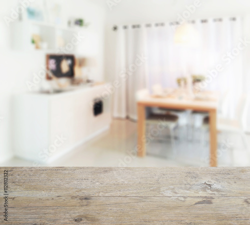 wooden table top with blur of wooden dining table next to pantry