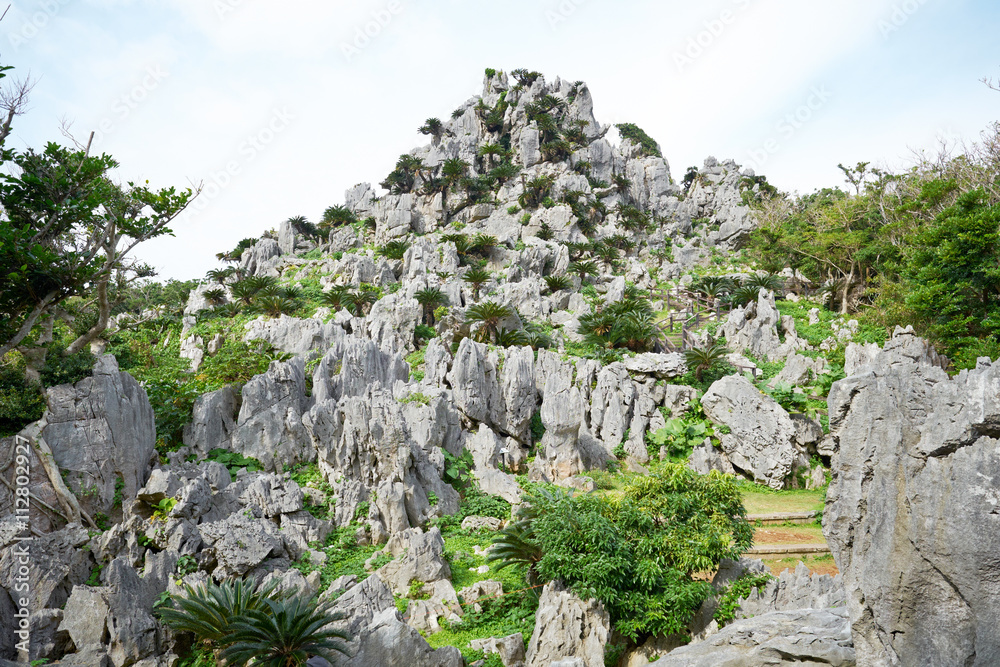 Ancient rock mountain and blue sky in Dai Sekirinzan park, Okinawa, Japan Ancient rock mountain and blue sky in Dai Sekirinzan park, Okinawa, Japan