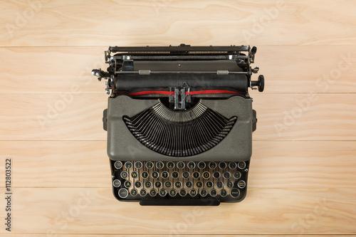 vintage typewriter isolated on wooden background