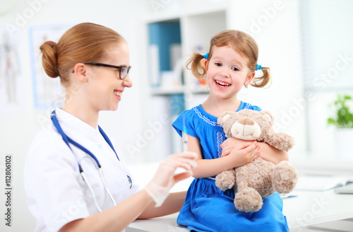 Doctor holds an injection vaccination child