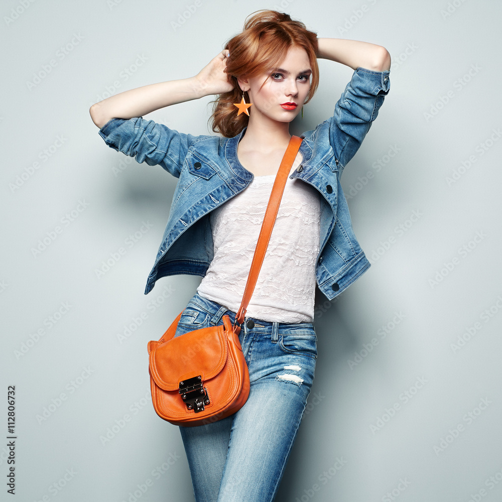 Fashion portrait of beautiful young woman with red hair. Girl in blouse and  jeans. Jewelry and hairstyle. Girl with handbag Stock Photo | Adobe Stock