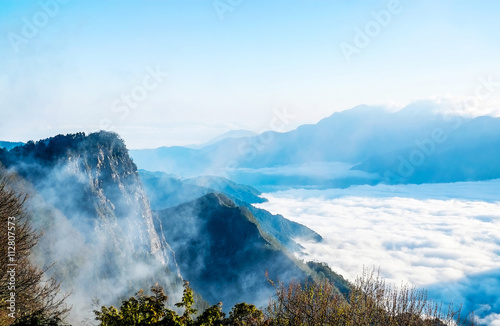 Beautiful morning sunrise  dramatic cloud of sea  giant rocks and Yushan mounatin under bright blue sky in Alishan Ali mountain  National Park  Taiwan