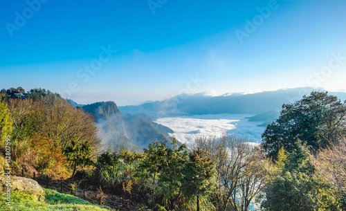 Beautiful morning sunrise, dramatic cloud of sea, giant rocks and Yushan mounatin under bright blue sky in Alishan(Ali mountain) National Park, Taiwan