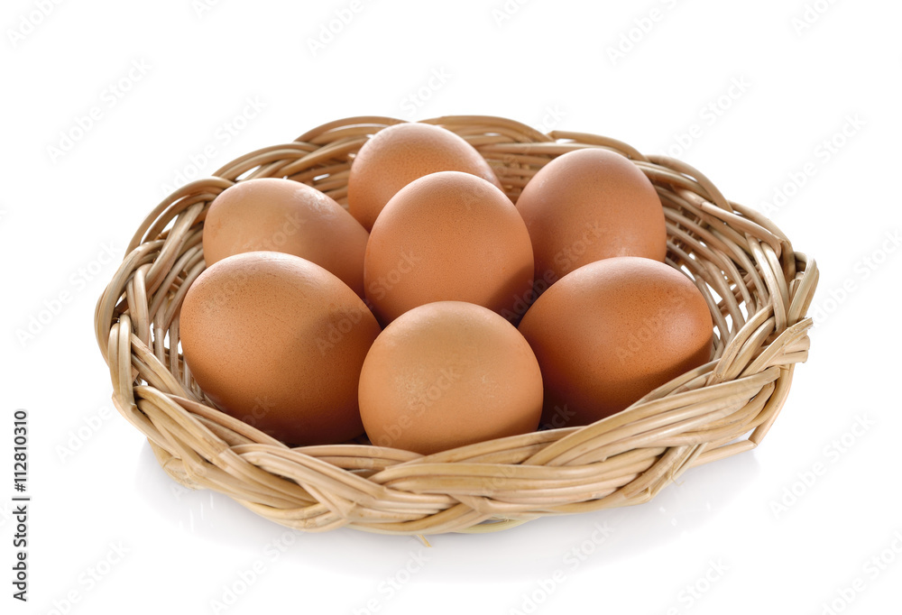 fresh eggs in the rattan basket on white background fresh eggs in the rattan basket on white background