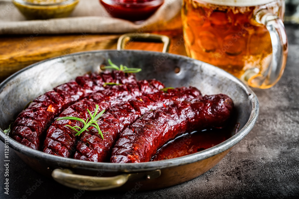 Sausage. Roasted chorizo sausage. Roasted spicy sausage chorizo home hotel or restaurant with beer vine brandy cognac whiskey. Still life. Toned photo. Sausage. Roasted chorizo sausage. Roasted spicy sausage chorizo home hotel or restaurant with beer vine brandy cognac whiskey. Still life. Toned photo.