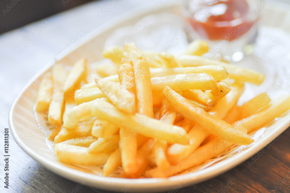 French fries dish and ketchup dip in soft focus